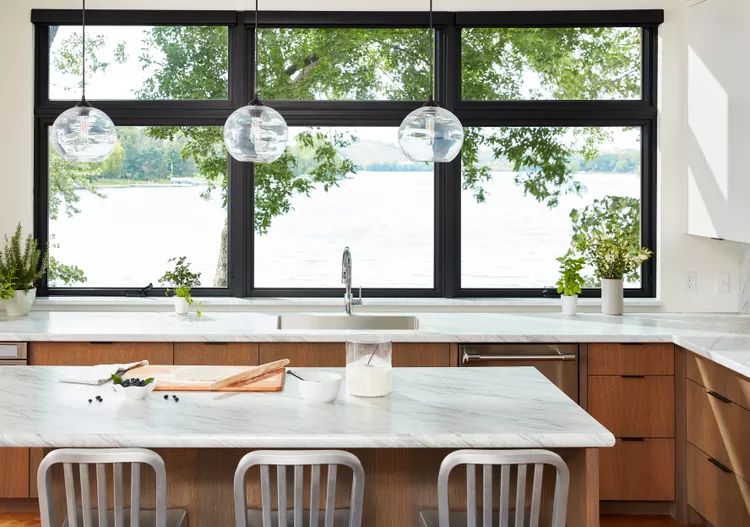 Premium titanium chef's knife on minimalist marble countertop with natural lighting - quality kitchen tools